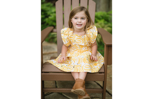 Toddler modeling vintage dress in bananas print