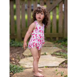 Toddler modeling baby bubble romper in bright popsicle print