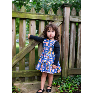 Toddler in girls pinafore dress