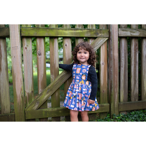 Toddler modeling girls pinafore dress