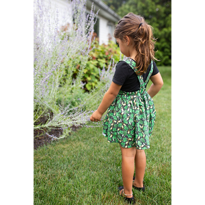 Back view of girls pinafore dress in herbs print