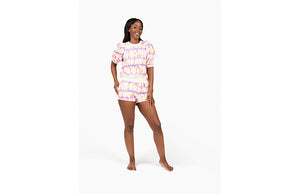 Model in Sunset Tie dye loungewear set: matching puff sleeve crew and shorts