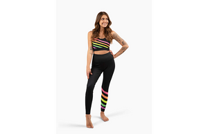 Model wearing matching black activewear loungewear set with neon stripes